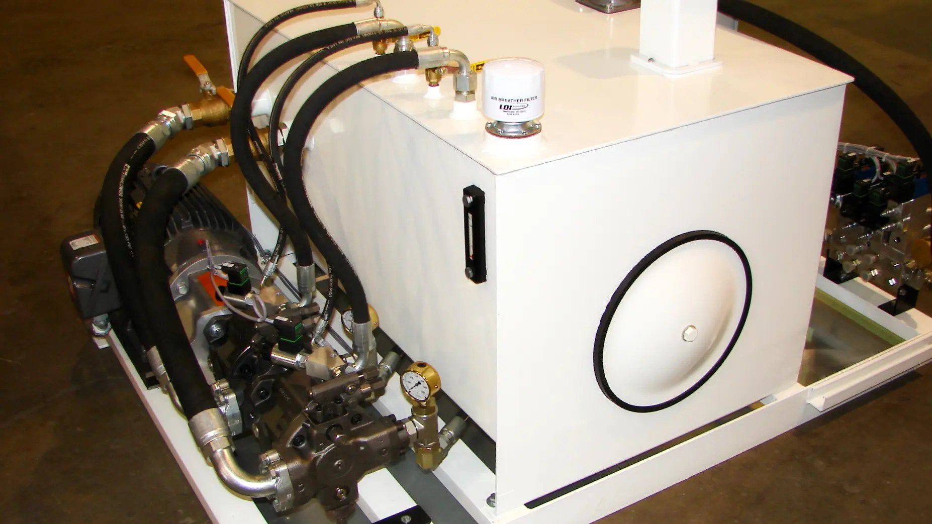 A white box with pipes and valves on top of it.