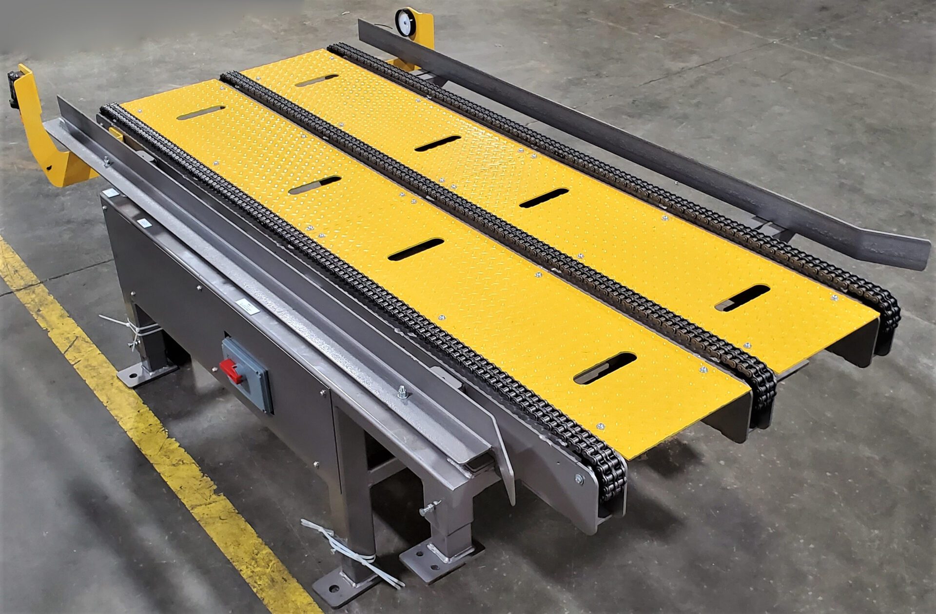 A yellow conveyor belt sitting on top of a metal table.