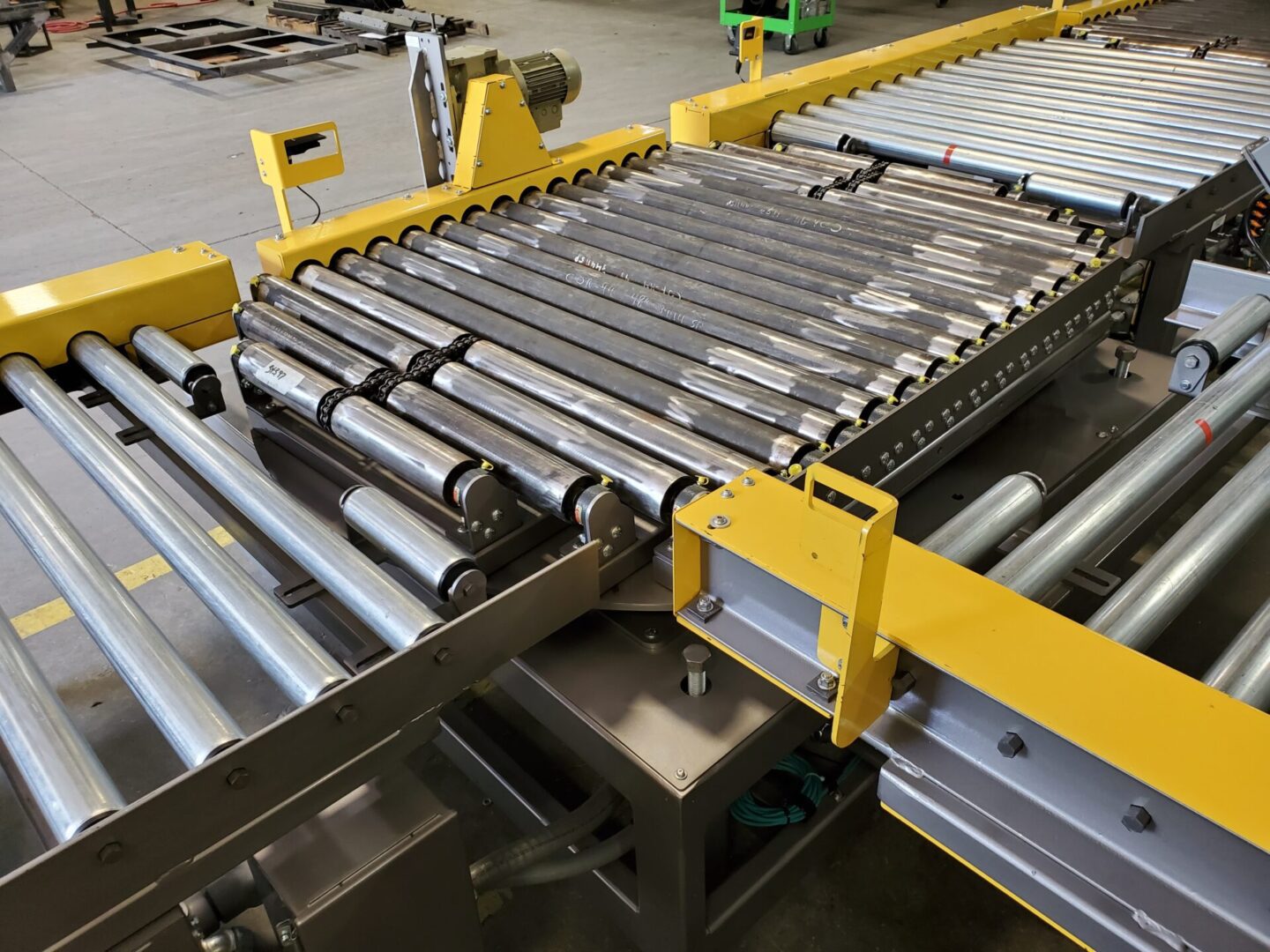 A conveyor belt with metal rollers on it.