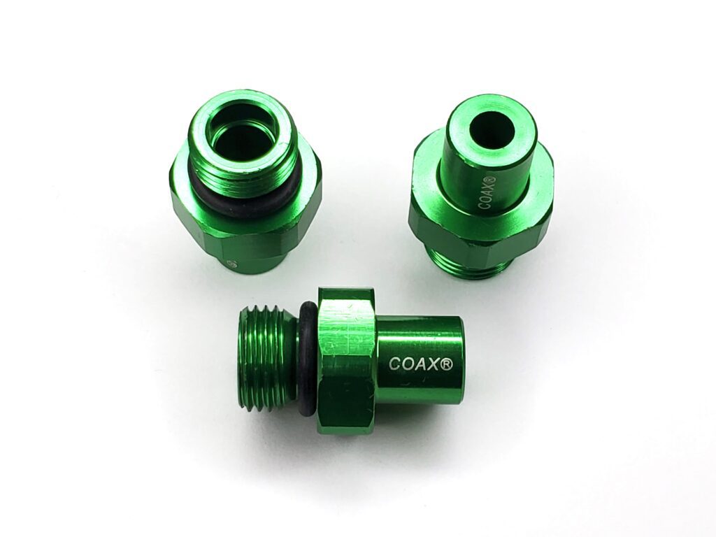 A set of three green anodized aluminum parts.